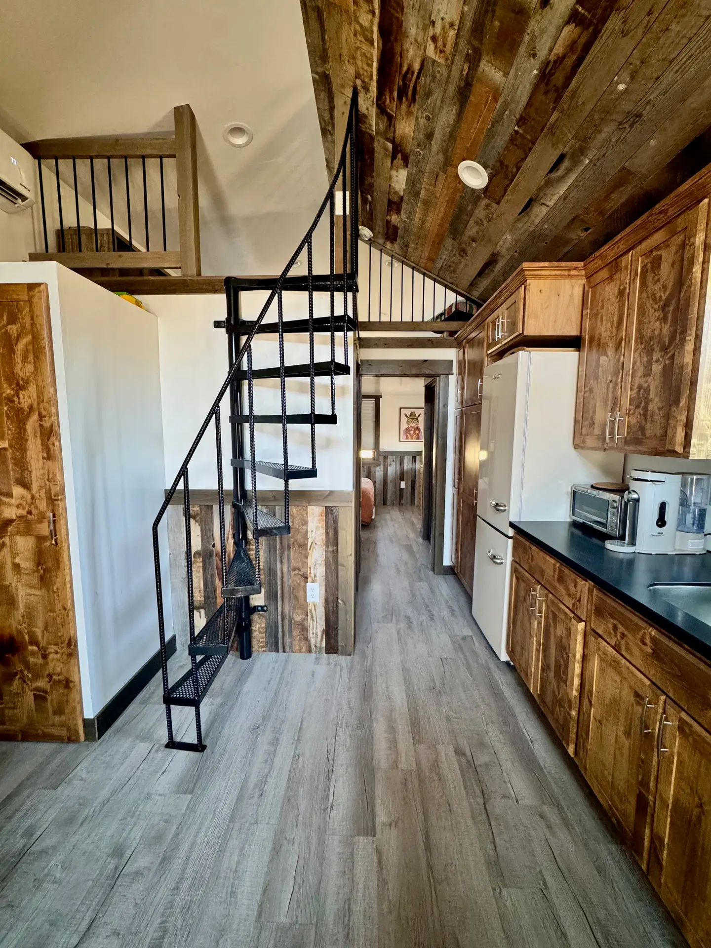 Spiral staircase and reclaimed barnwood ceiling inside the Stargazer cabin